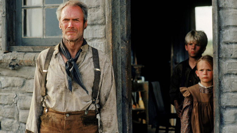 Clint Eastwood as Will Munny at his farmhouse with his two children
