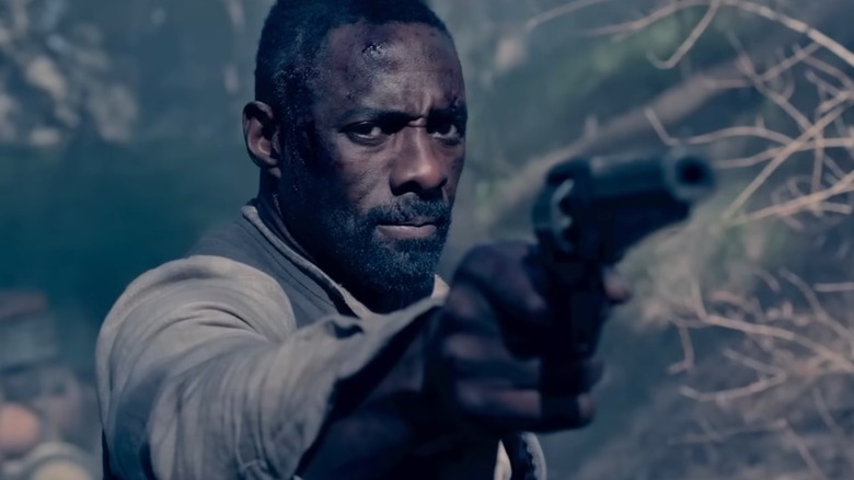 Idris Elba as The Gunslinger aiming his gun