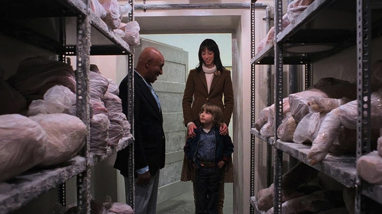 Scatman Crothers' Dick Hallorann stands alongside Shelley Duvall's Wendy Torrance and Danny Lloyd's Danny Torrance in a walk-in freezer in The Shining