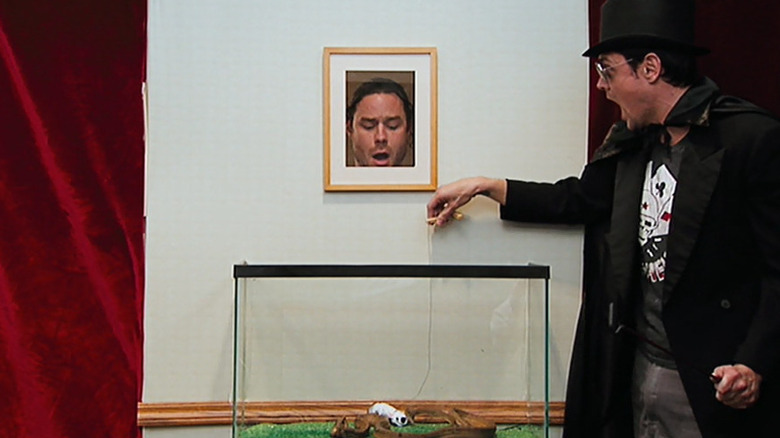 Johnny Knoxville, right, performs a puppet show for a live snake, featuring part of Chris Pontius in Jackass:The Movie