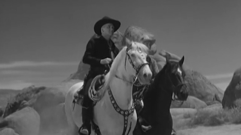 William Boyd's Hopalong Cassidy sits on a horse next to his sidekick in Hopalong Cassidy