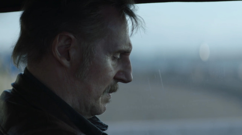Bullet looks at Liam Neeson sitting in a car in forgiveness