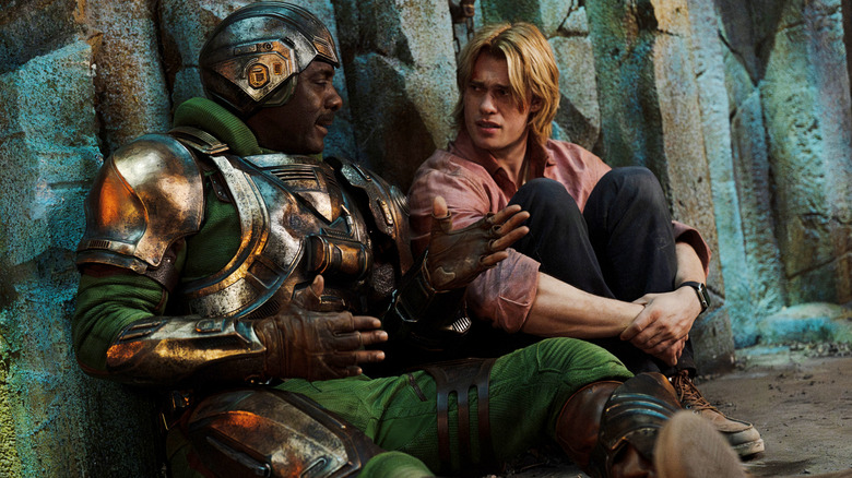 Man at Arms (Idris Elba) chats with Prince Adam (Nicholas Galitzine) in Masters of the Universe