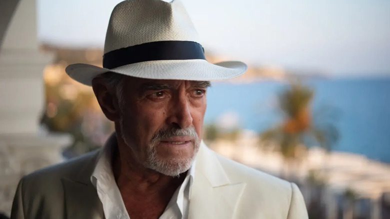 Superspy John Diman wearing a white casual suit with hat and looking perturbed in Reflection in a Dead Diamond