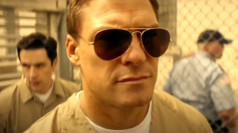 Jack Reacher wearing sick shades in prison in Reacher