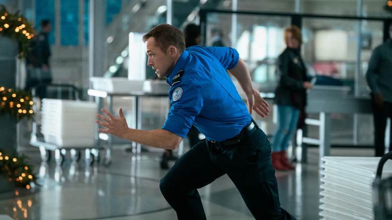 Ethan Kopek runs through the airport in Carry-On