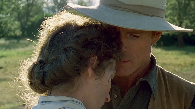 Meryl Streep as Karen and Robert Redford as Denys standing close together in Out of Africa