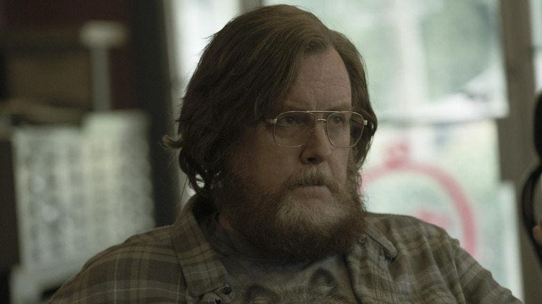 Steve Agee as John Economos looking despondent in season 1 of Peacemaker