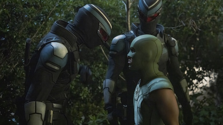 Freddie Stroma as Vigilante staring down Nhut Le as Judomaster in season 2 of Peacemaker