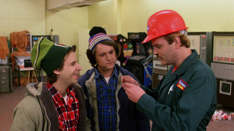 Rick Moranis as Bob McKenzie and Dave Thomas as Doug McKenzie chat excitedly with a construction worker in Strange Brew