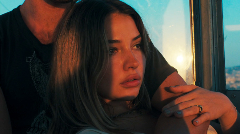 Madeleine Klein in the role of Heather Molgro from the back by KJ APA as Kajak in the map that leads you