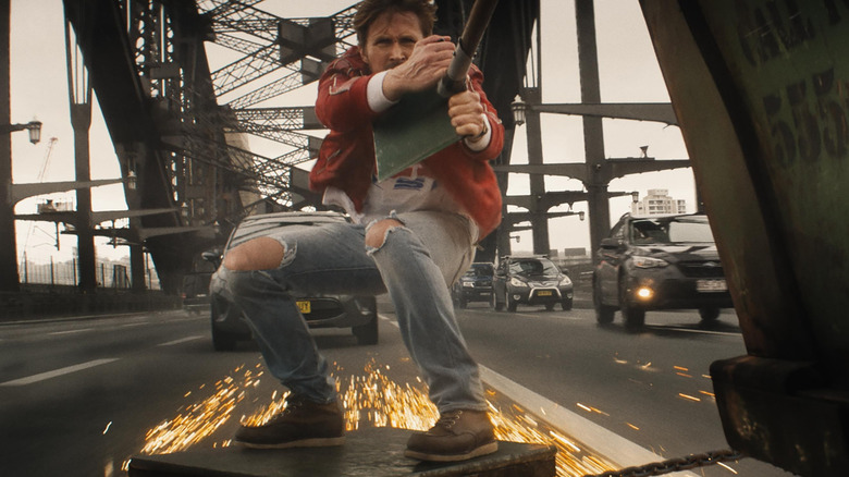 Colt riding alongside a truck on a highway in The Fall Guy