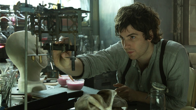 Adam tinkering with a contraption in Upside Down