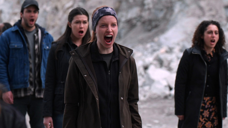 A woman with her mouth wide open in an episode of Debris