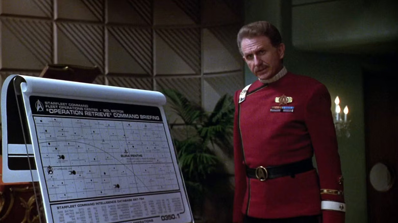 Colonel West stands next to a sticker plate in Star Tery