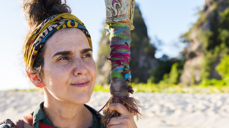 Aubry holding her torch on the beach on Survivor 50