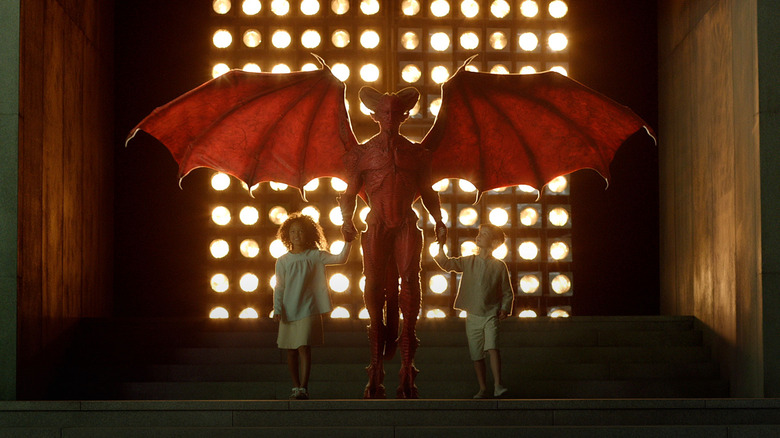 An Overlord holding the hands of two children in Childhood's End