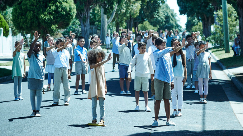 A group of children waving their hands in unison in Childhood's End