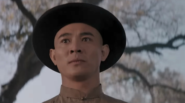 Jet Li's Wong Fei-hung is seen from a low angle as he stands by a tree in Once Upon a Time in China and America