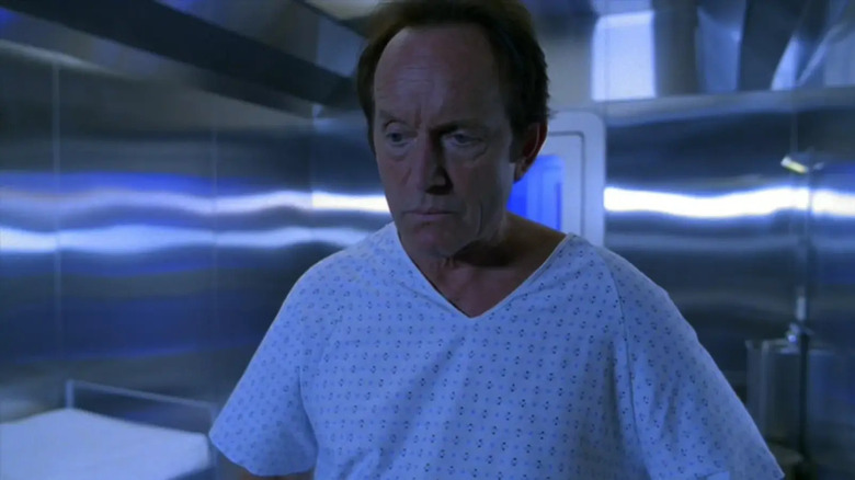 Frank Black waking up in a steel room in hospital scrubs in Millennium