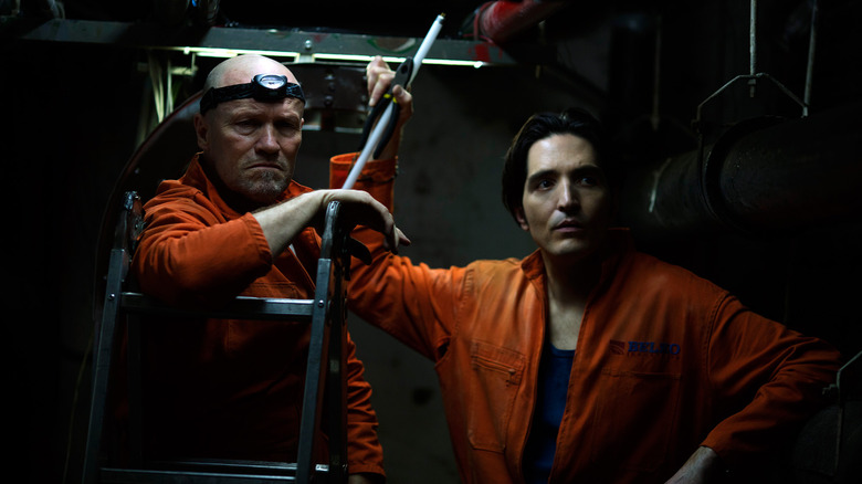 Michael Rooker as Bud and David Dastmalchian as Lonny wearing orange jumpsuits in The Belko Experiment