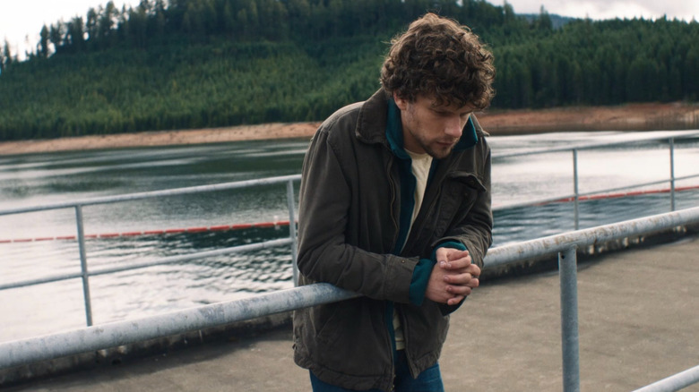 Josh standing over a dam in Night Moves