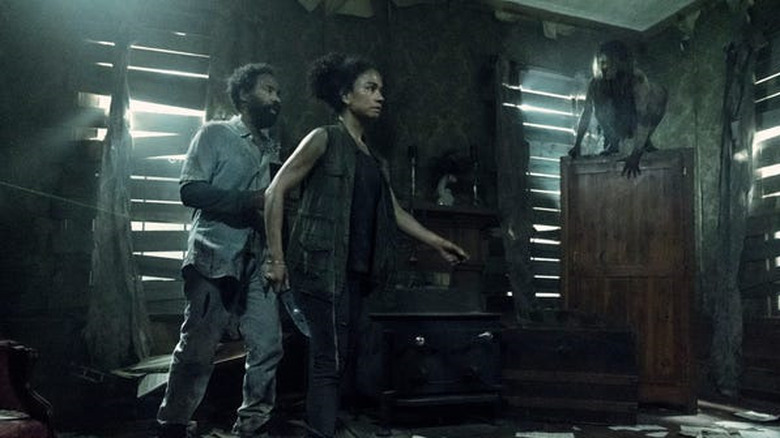 Connie (Lauren Ridloff) and Virgil (Kevin Carroll) square off with feral people in The Walking Dead episode "On the Inside"