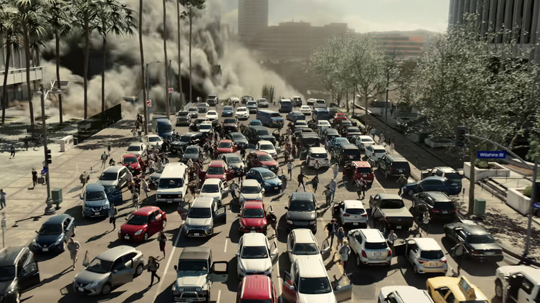 A sinkhole opens on a busy Los Angeles street as people flee their cars in La Brea