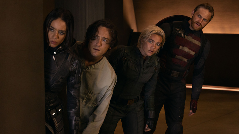 Hannah John-Kamen as Ghost, Lewis Pullman as Bob, Florence Pugh as Yelena Belova, and Wyatt Russell as John Walker peering around a corner in Thunderbolts