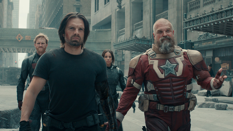 Sebastian Stan as Bucky and David Harbour as Red Guardian walking down the streets of New York with John Walker and Ghost behind them in Thunderbolts
