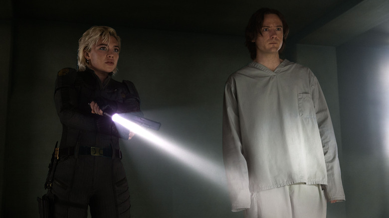 Florence Pugh as Yelena Belova and Lewis Pullman as Bob wandering around Val's warehouse in Thunderbolts