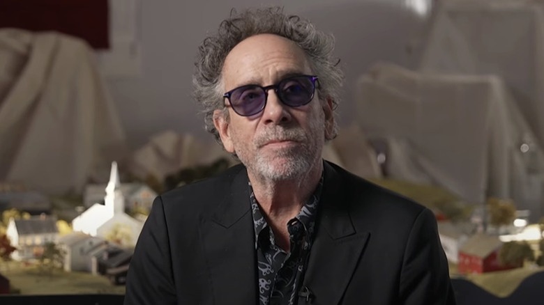 Tim Burton sits in front of the Beetlejuice Beetlejuice model