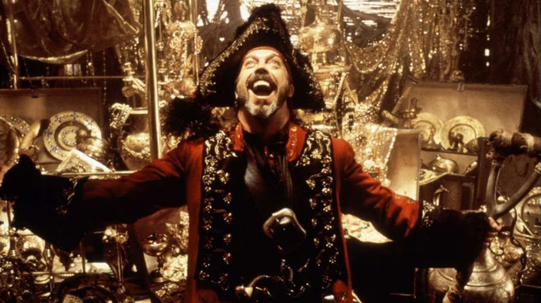 Long John Silver laughing in front of piles of treasure on Muppet Treasure Island
