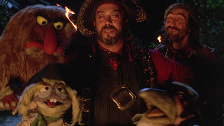 Long John Silver surrounded by human and Muppet pirates in Muppet Treasure Island