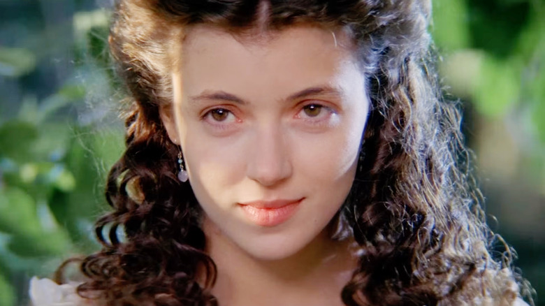 Mia Sara as Lili looking happy in a forest in Legend