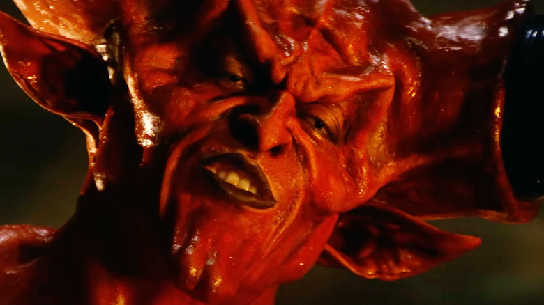 Tim Curry as Darkness smiling confidently in Legend