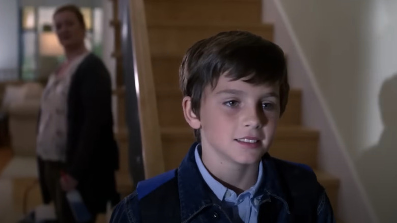 Timothee Chalamet as Eric Foley standing by some stairs in Law & Order