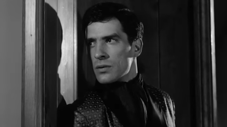 John Cassavetes' Robert Batsford is seen in closeup standing in a door frame in The Night Holds Terror