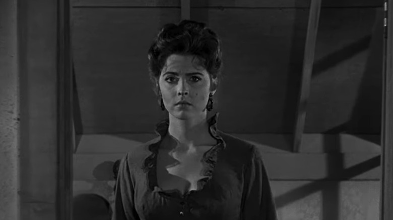 Tina Louise's Helen Crane stands in a doorway in Day of the Outlaw