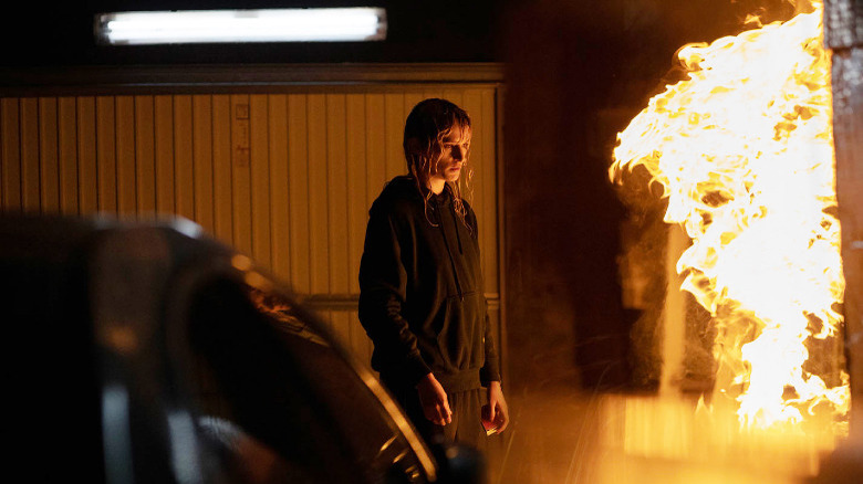 Alexia staring at a fire in Titane