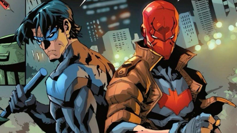 Nightwing and Red Hood posed back-to-back in