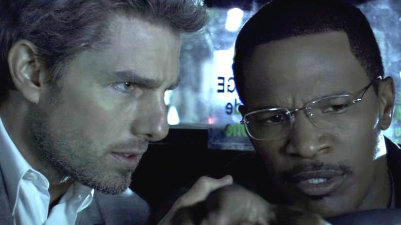Tom Cruise as Vincent threatens Jamie Foxx as Max in a cab in Collateral