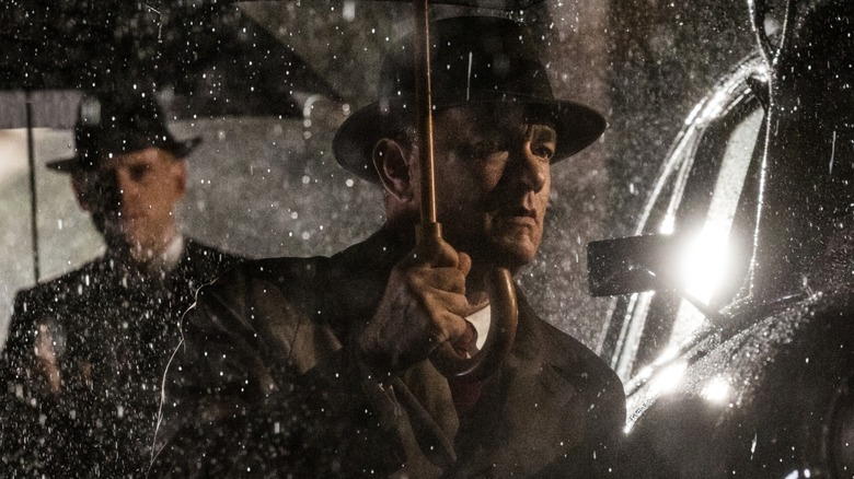 Donovan holds an umbrella to shield himself from the rain in Bridge of Spies