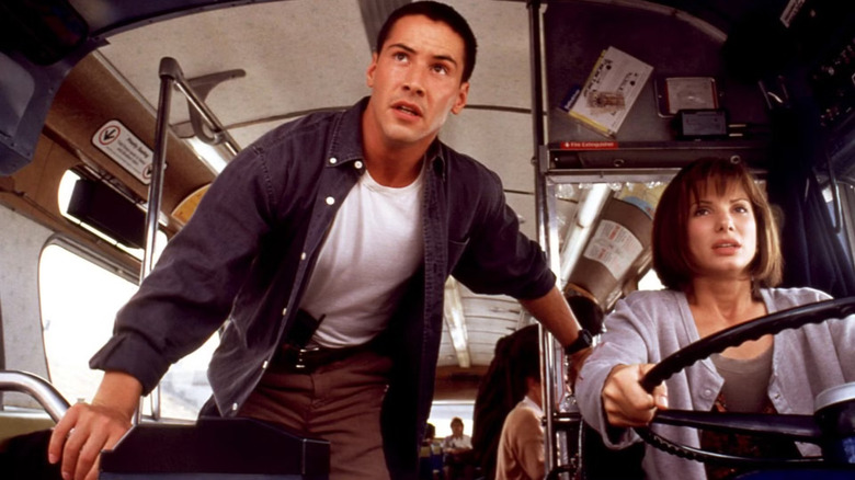 Jack Traven next to Annie Porter, driving a bus, in Speed