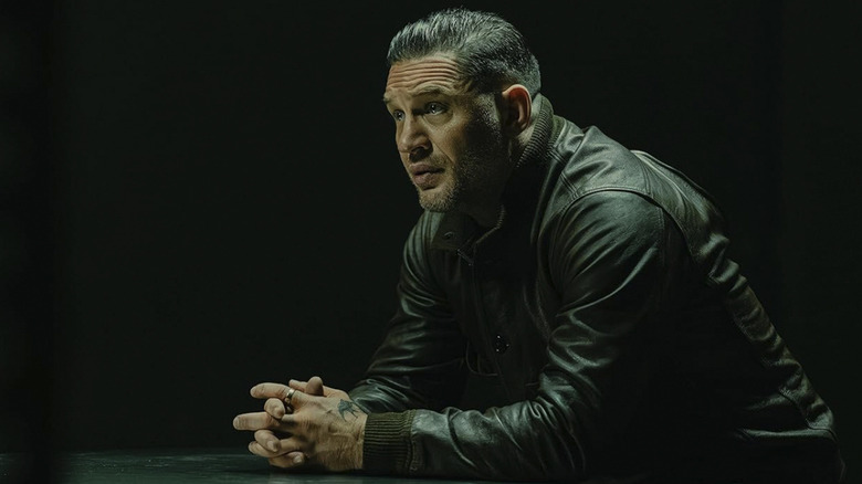 Harry Da Souza sits and looks intense