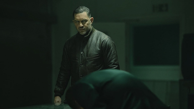 Harry Da Souza stands and looks intense