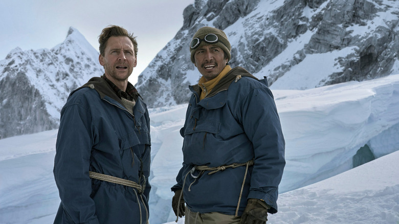 Tom Hiddleston as Sir Edmund Hillary and Denden Phuntsok as Tenzing Norgay standing on a snowy mountain in Tenzing