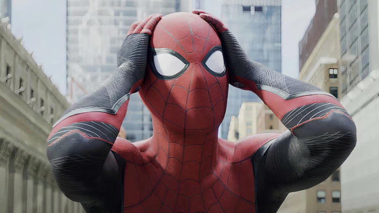 Spider-Man (Tom Holland) clutches his head in shock at the end of Spider-Man: Far From Home