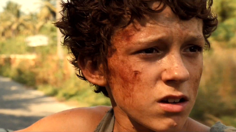 Tom Holland is bloodied and bruised as Lucas Bennett in The Impossible