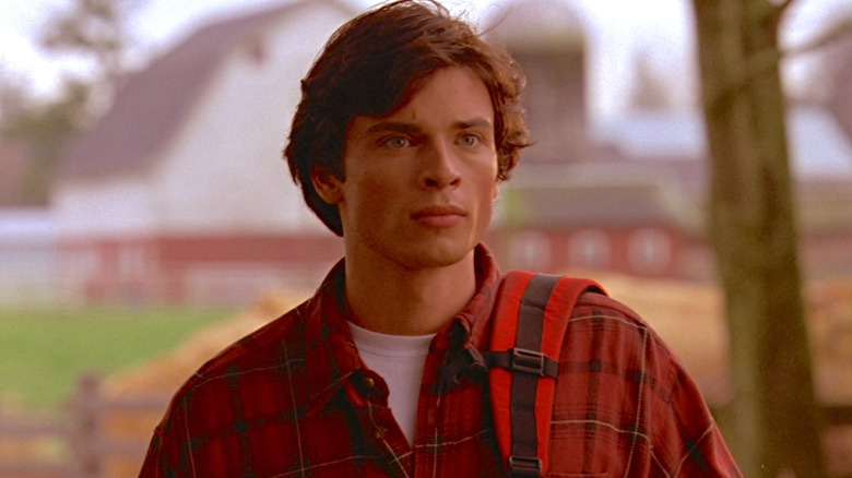 Tom Welling as Clark Kent wearing a red shirt in Smallville.